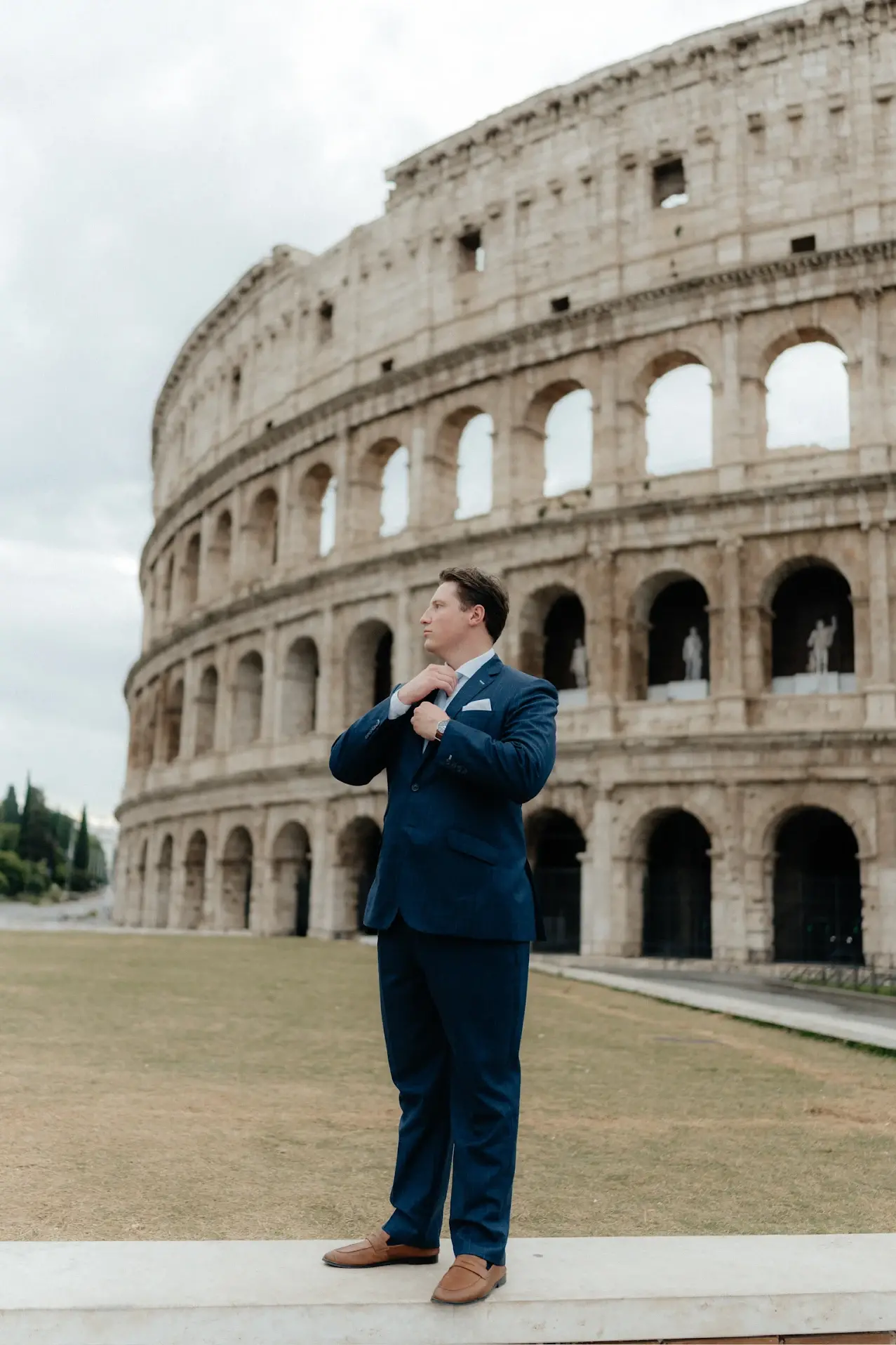 Groom in custom wedding suit by esatto Custom sitting down at his wedding in Italy