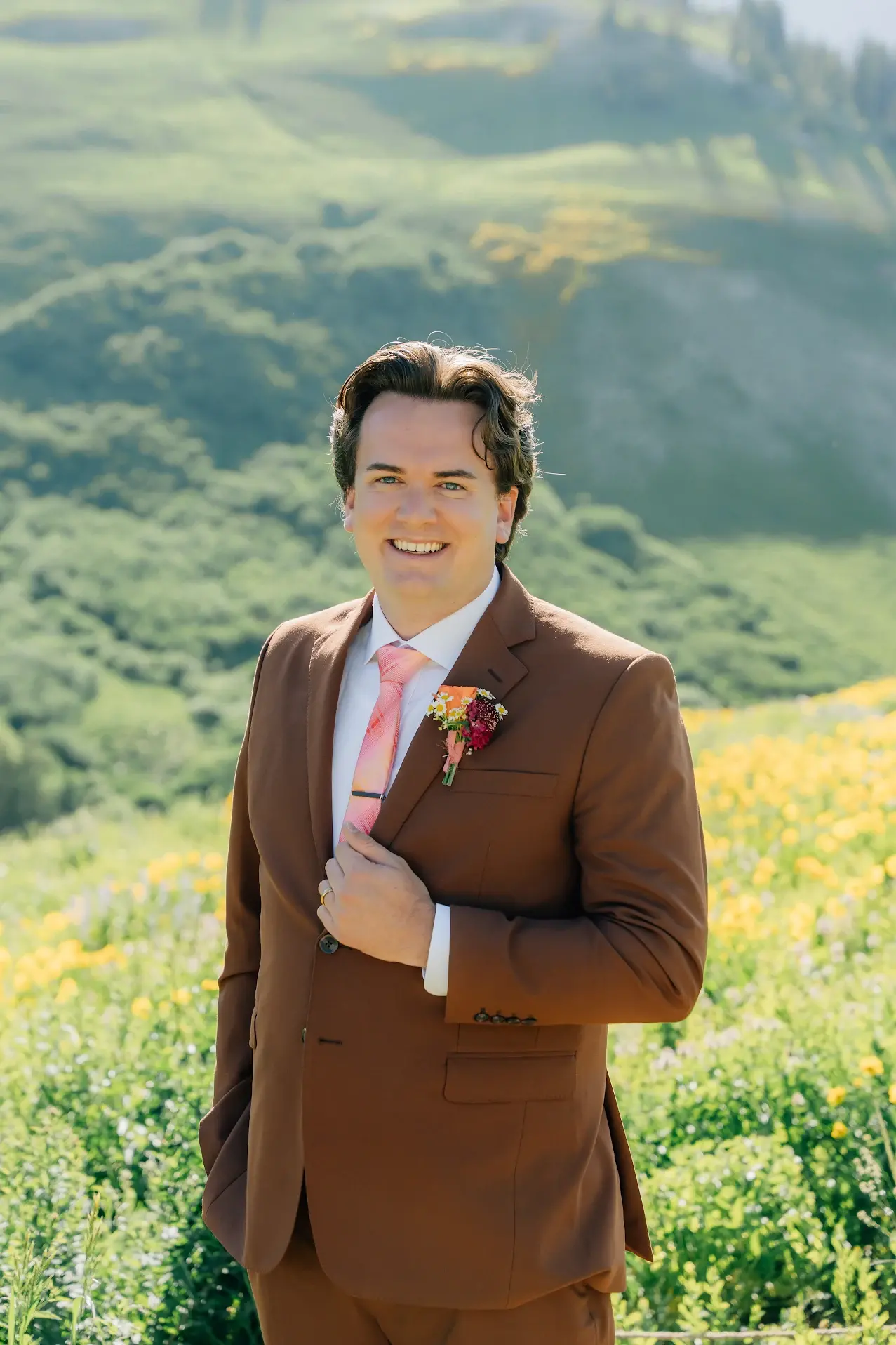 Groom wearing custom green wedding suit by esatto Custom during wedding photos