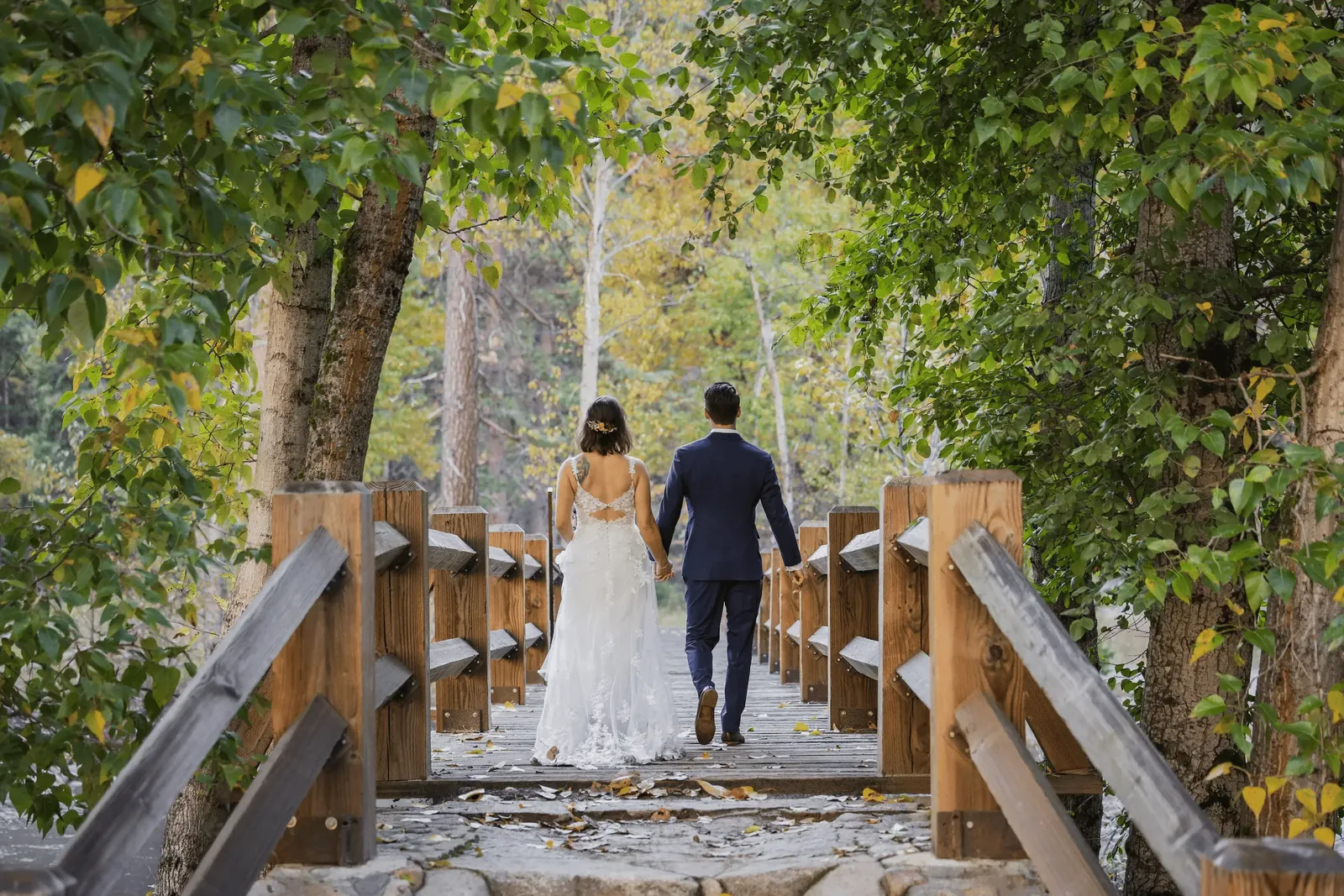 Groom in custom navy blue wedding suit by esatto Custom at his wedding reception