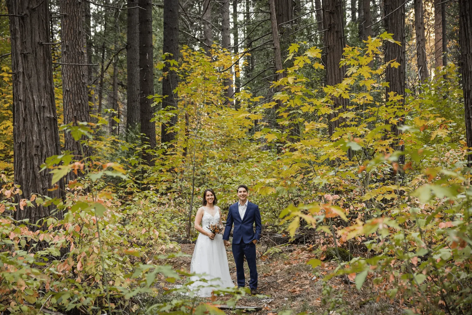 Wedding couple with groom in custom navy blue wedding suit by esatto Custom
