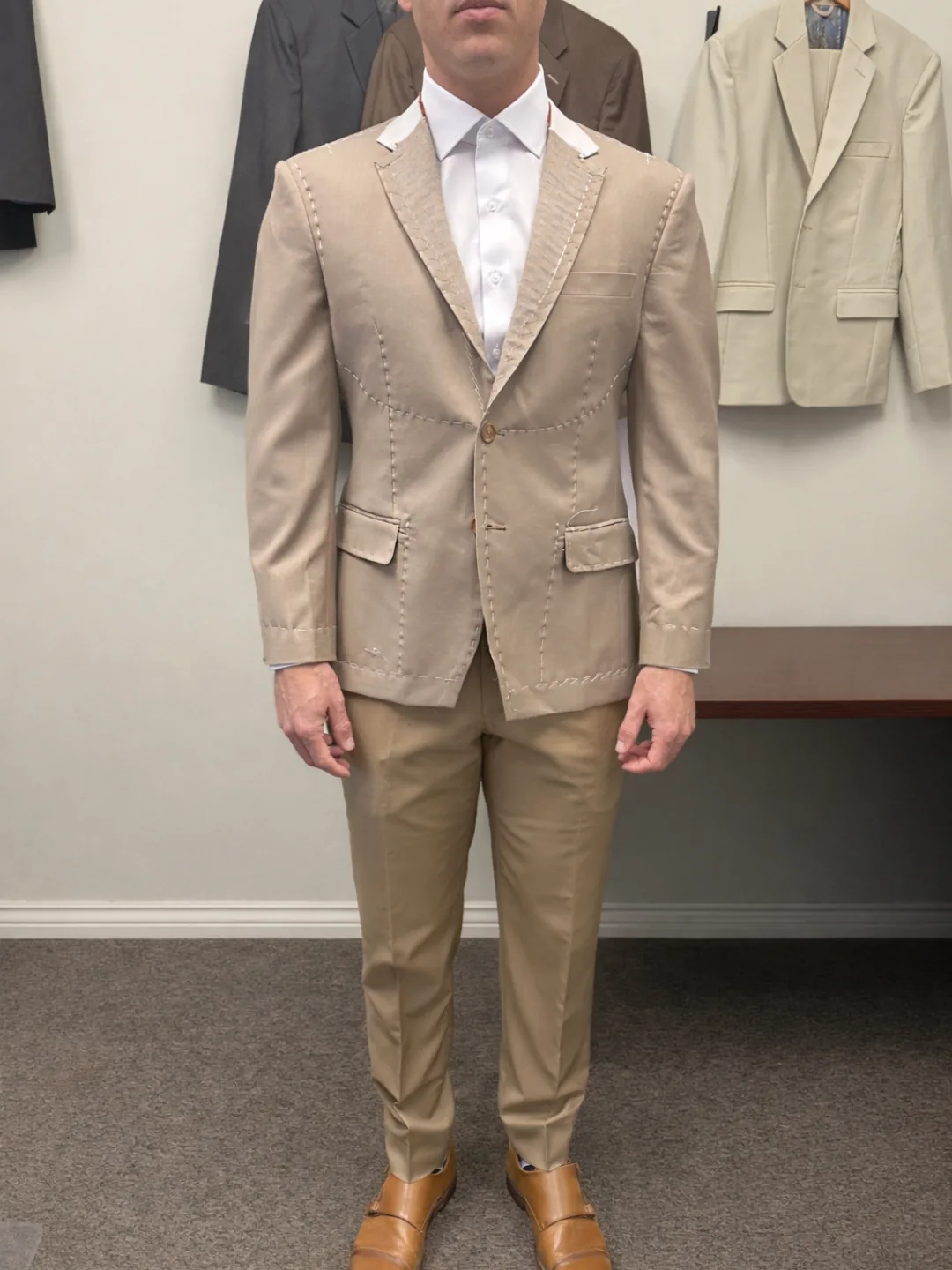 Client in a tan custom suit and white shirt at a fitting in the esatto Custom studio, Layton, Utah